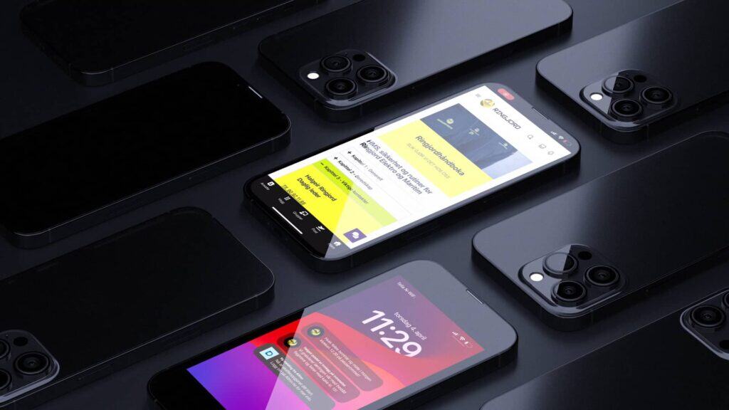 Flere svarte smarttelefoner er plassert på en mørk overflate. To skjermer er opplyst: den ene viser en nettside med gul og hvit layout, den andre viser en rød og lilla digital klokke som viser 11:29.